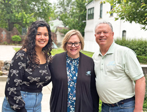 Dorcas Marrero, left, poses with Tricia Byrd, residential program director for St. Elizabeth Catholic Charities in New Albany, and agency director Mark Casper in the agency’s Holy Trinity Park on May 30. (Photo courtesy of Cantaloupe)