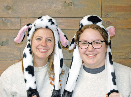 Rachel Gilman, left, director of youth ministry for the archdiocese, and Avery Shewmaker, coordinator of youth ministry for the archdiocese, model some of the spirit wear that the 1,526 youths in the archdiocese will wear during the National Catholic Youth Conference in Indianapolis on Nov. 20-22. (Photo by John Shaughnessy)