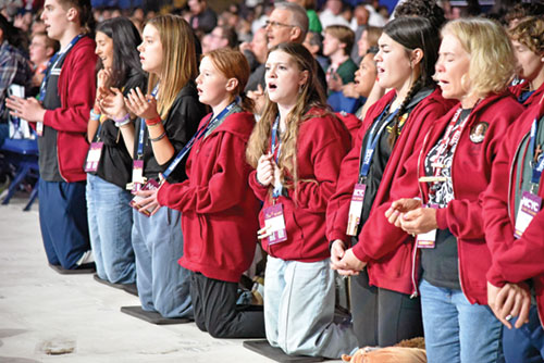 National Catholic Youth Conference participants from the Diocese of Charleston, S.C., kneel in prayer during the event&rsquo;s closing Mass on Nov. 22 in Lucas Oil Stadium in Indianapolis. (Photo by Sean Gallagher)