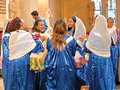 After a Mass celebrating Christmas on Jan. 10 in St. Michael the Archangel Church in Indianapolis, women of the Eritrean and Ethiopian Catholic community choir radiate joy as they perform a traditional shebshebo dance rejoicing at the birth of Christ. According to the Ge&rsquo;ez rite calendar used by the Eritrean and Ethiopian Churches, Christmas is celebrated on Dec. 29, which is Jan. 7 on the Gregorian calendar used by most of the world. (Photo by Natalie Hoefer)