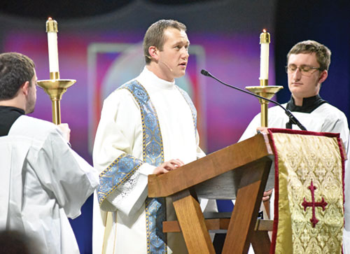 Transitional Deacon Sam Hansen proclaims the Gospel during the closing Mass of the National Catholic Youth Conference on Nov. 22, 2025, at Lucas Oil Stadium in Indianapolis. (File photo by Sean Gallagher)