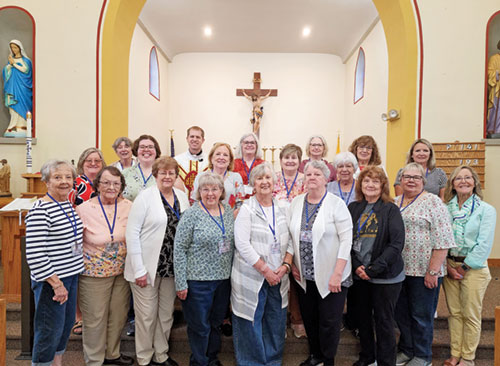 Women from St. Mark Parish in Perry County and St. Paul Parish in Tell City pose in St. Mark Church during a women&rsquo;s retreat on April 18. They are joined by their pastor Father Anthony Hollowell in the back row, who celebrated Mass during the retreat. (Submitted photo)