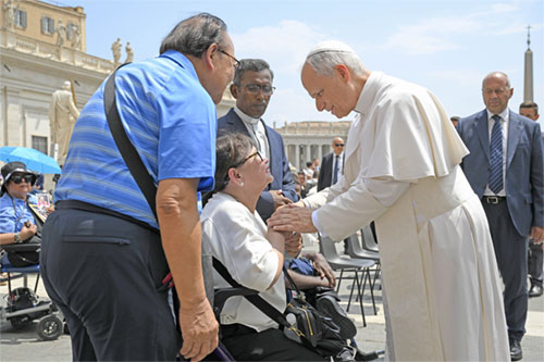 Pope Leo XIV blesses a woman in St. Peter's Square after his general audience at the Vatican June 18, 2025. (CNS photo/Vatican Media)