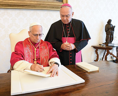 Pope Leo XIV signs his first apostolic exhortation, “Dilexi Te” 
(“I Have Loved You”), in the library of the Apostolic Palace at the Vatican on Oct. 4, the feast of St. Francis of Assisi, as Archbishop Edgar Peña Parra, the substitute secretary for general affairs at the Vatican Secretariat of State, looks on. The exhortation was to be released on Oct. 9. (CNS photo/Vatican Media)