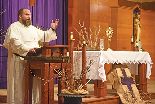 Dominican Father Patrick Hyde, pastor of St. Paul Catholic Center in Bloomington, speaks about the Eucharist on March 16, 2023, during a eucharistic evening of reflection at Holy Family Church in New Albany. As a national eucharistic preacher commissioned in 2022 by the U.S. Conference of Catholic Bishops, Father Patrick has spoken about the Eucharist across the country and in many archdiocesan parishes. (File photo by Sean Gallagher) 