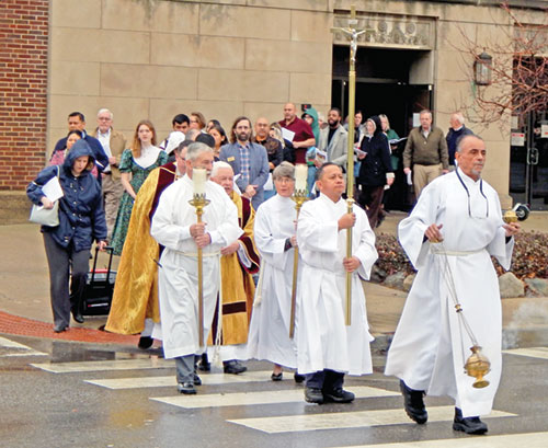 People process across Meridian Street from the Archbishop Edward T. O’Meara Catholic Center to SS. Peter and Paul Cathedral on Dec. 29 after a prayer service to mark the start of the 2025 Jubilee Year, whose theme is “Pilgrims of Hope.” (Photo by Mike Krokos)