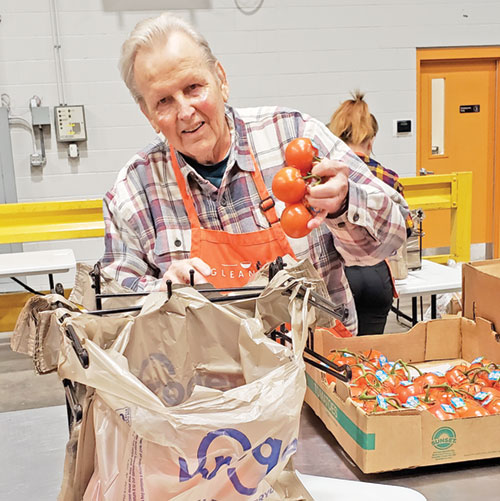 John Kordes, a member of St. Christopher Parish in Indianapolis, enjoys volunteering to help alleviate hunger in his local community—in this case, filling bags with tomatoes at Gleaners Food Bank in Indianapolis on Jan. 2. (Photo by Natalie Hoefer)
