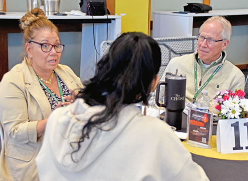 Jeff McQueen, right, a volunteer for several ministries at St. Susanna Parish in Plainfield, listens to Veronica Castillo-Rogers, left, director of youth faith formation and teen ministries at St. Patrick Parish in Terre Haute, on April 8 during a workshop on the U.S. Conference of Catholic Bishops’ “Listen Teach Send” document. Written for ministries of youths and young adults, the listen-teach-send method also serves as a dynamic model for evangelization. (Photo by Natalie Hoefer)