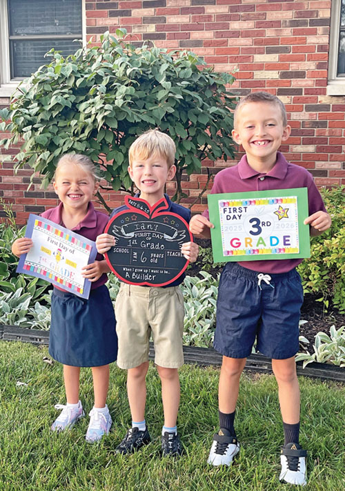 Karlynn Andrews, left, and her brother Emmett Andrews, right, pose for a photo with their cousin, Ian Hartkorn, on the first day of school. The three children attend St. Barnabas School in Indianapolis. (Submitted photo)