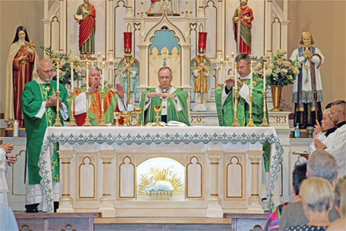 Archbishop Charles C. Thompson prays the eucharistic prayer during a Mass on Aug. 16 marking the 175th anniversary of St. Joseph Parish in Jennings County. With him at the altar are, left, Deacon Lawrence French, Father Christopher Craig and Father Jonathan Meyer. (Submitted photo by Jennifer Lindberg)