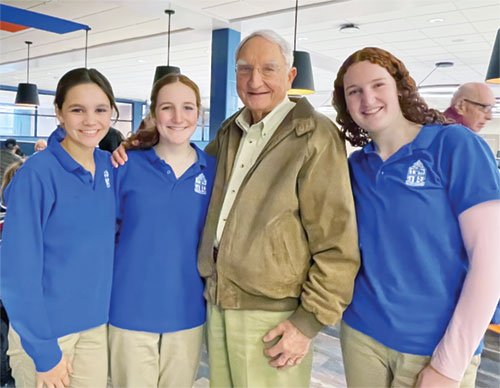 Frank Otte, Sr., a U.S. Army veteran and helicopter pilot, shares a family moment with granddaughters Helen Otte, left, Emma Clare Becker and Charlotte Becker during a Veterans Day celebration and Mass at Bishop Chatard High School in Indianapolis on Nov. 11, Veterans Day. (Submitted photo)