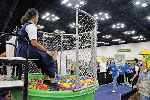 Alana Brooks-Murphy, an aspirant in the Salesian Sisters, sits atop a dunk tank on Nov. 20 in her religious community&rsquo;s booth in the Indiana Convention Center in Indianapolis during the National Catholic Youth Conference held from Nov. 20-22. Some 16,000 Catholic teenagers from across the country came to Indianapolis for the conference. (Photo by Sean Gallagher)