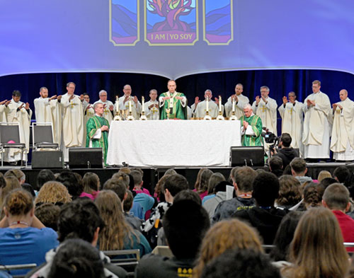 Archbishop Charles C. Thompson and priests throughout central and southern Indiana offer the eucharistic prayer during a special Mass for archdiocesan participants at the National Catholic Youth Conference at the Indiana Convention Center in Indianapolis on Nov. 20. (Photo by Natalie Hoefer)