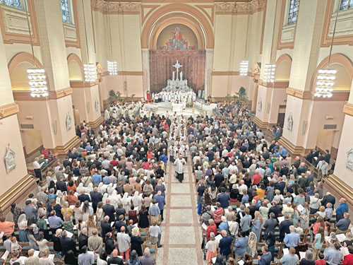 Worshippers fill SS. Peter and Paul Cathedral in Indianapolis on June 7, 2025, as seminarians and priests process out of the cathedral after a Mass in which three men were ordained priests for the Archdiocese of Indianapolis. (Photo by Sally Krause)