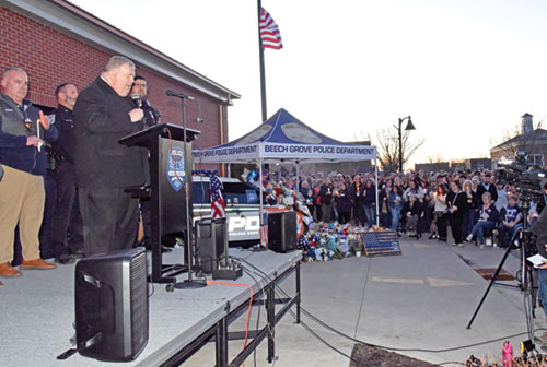 Father Robert Robeson speaks on Feb. 18 during a candlelight vigil for Brian Elliott, a member of the Beech Grove Police Department who was shot and killed in the line of duty on Feb. 16. The vigil took place outside of the department&rsquo;s police station. Father Robeson is pastor of Holy Name of Jesus Parish in Beech Grove. (Photo by Sean Gallagher)