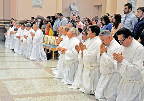 Deacon candidates from across the archdiocese kneel in prayer during a June 24, 2017, Mass in SS. Peter and Paul Cathedral in which 21 men from across the archdiocese were ordained as permanent deacons. (File photo by Sean Gallagher)