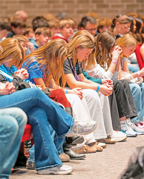 Times of prayer and reflection were part of the Holy Fire event on Feb. 28 at the Pike Performing Arts Center in Indianapolis. It also included ice-breaking moments of a dance party and a performance by a magician. (Photo courtesy of Madeleine Budde)