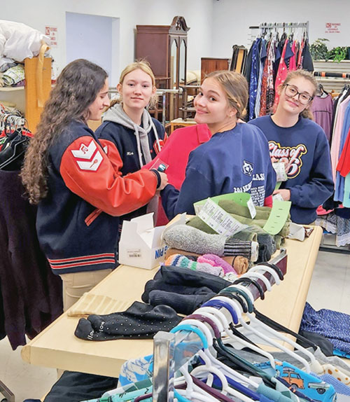 Elizabeth Daoud,&nbsp;left, MeKenzie McDonald,&nbsp;Kaydence Burkhardt and Lillian Thomas, all seniors at Seton Catholic High School in Richmond, help prepare Good Samaritan Center in Richmond for its opening on March 21. (Submitted photo by Dan Reichley)