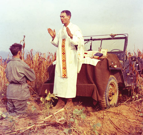 Father Emil Joseph Kapaun, a U.S. Army chaplain, is pictured celebrating Mass from the hood of a jeep Oct. 7, 1950, in South Korea. While he continued treatment at Rome's Gemelli hospital, Pope Francis issued a series of decrees regarding several sainthood causes Feb. 24, 2025, including for Father Kapaun, a U.S. Army military chaplain who died in a prisoner of war camp in North Korea in 1951. The pope recognized his sacrifice as an "offering of life," a category distinct from martyrdom that the pope established in 2017. (OSV News photo/courtesy U.S. Army medic Raymond Skeehan)