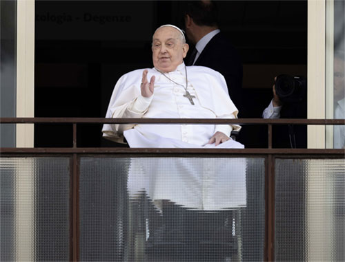 Pope Francis waves to a crowd of well-wishers at Rome's Gemelli hospital before returning to the Vatican March 23, 2025, after 38 days of treatment at the hospital. (CNS photo/Pablo Esparza)