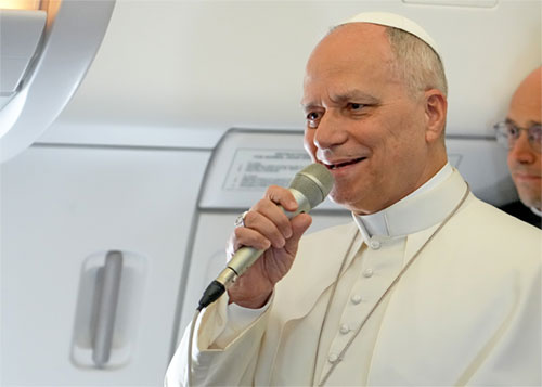 Pope Leo XIV speaks to reporters aboard the papal flight from Rome, Italy, to Algeria April 13, 2026. (CNS photo/Lola Gomez)