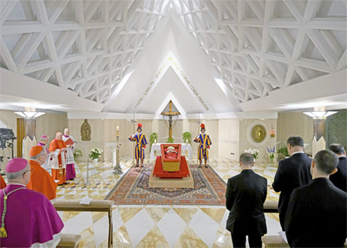 Pope Francis lies at rest in his coffin in the chapel of his residence, the Domus Sanctae Marthae, at the Vatican as cardinals and his closest aides pray April 21, 2025. (CNS photo/Vatican Media)