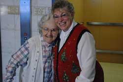 Mary Pietz, left, a resident of St. Paul Hermitage in Beech Grove, poses near the elevator on Dec. 12 with Benedictine Sister Sharon Bierman, administrator of the facility that has cared for more than 1,000 elderly residents since its founding in 1960. St. Paul Hermitage is one of the main ministries of Our Lady of Grace Monastery in Beech Grove.