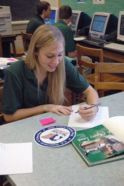 Shawe Memorial High School senior Alyssa Richard works on a yearbook page layout on Jan. 11 about the Madison school’s designation as a national Blue Ribbon School of Excellence.