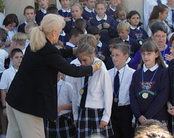 Christine Cohn, U.S. Department of Education official, celebrates with St. Christopher students in Indianapolis after their school was named a Blue Ribbon School of Excellence. (File photo by Brandon A. Evans)