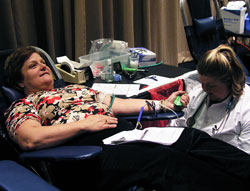 Rita Parsons, left, donates blood with the help of an unidentified nurse during the blood drive at the National Catholic Educational Association convention in Indianapolis on March 26. The principal of Holy Spirit School in Indianapolis, Parsons was one of 104 people who donated blood to show the attitude of giving of yourself. (Photo by John Shaughnessy) 