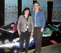 Finnish principal Kaija-Leena Salovaara, left, and Annette Jones, principal at Immaculate Heart of Mary School in Indianapolis, stand in front of a race car exhibit at the National Catholic Educational Association convention at the Indiana Convention Center in Indianapolis on March 26. (Photo by Mike Krokos) 