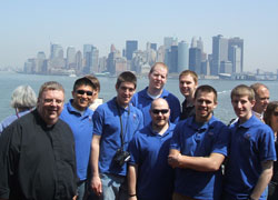 Father Robert Robeson, left, rector of the Bishop Simon Bruté College Seminary in Indianapolis, stands with seminarians on the Staten Island Ferry during their trip to New York to attend the Mass on April 20 at Yankee Stadium with Pope Benedict XVI. The seminarians are, from left, Martin Rodriguez, Gregory Lorenz, Timothy Wyciskalla, Adam Ahern, Andrew Proctor, Benjamin Syberg and Daniel Bedel. All except Ahern are archdiocesan seminarians. Ahern is affiliated with the Archdiocese of Cincinnati. (Submitted photo) 