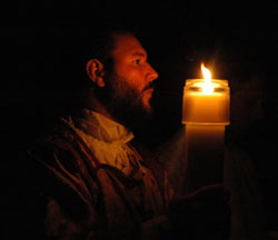 Deacon Aaron Jenkins with the Easter candle. (Photo by Sean Gallagher) 