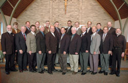 Posing for a class picture on Aug. 23 in the chapel of Our Lady of Fatima Retreat House in Indianapolis are, front row, from left, Benedictine Father Bede Cisco, deacon aspirants Frank Roberts, Rick Renzi, Rick Cooper, Mark Meyers, Ron Pirau, Joe Geiman, Mike Slinger, Rick Wagner, Jeff Powell and Father Lawrence Voelker. In the back row are from left, Deacon Kerry Blandford and deacon aspirants Tom Hill, Mike Braun, Jim Miller, Brad Anderson, Tom Harte, Steven House, Russ Woodard, Tom Horn and Ron Freyer. (Photo by Sean Gallagher) 