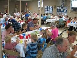 Members of St. Charles Borromeo Parish in Milan in the Batesville Deanery share a meal together on Aug. 23 after a Mass that celebrated the 100th anniversary of the parish’s founding. (Submitted photo) 