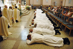 The 25 archdiocesan deacon candidates lay prostrate in prayer during the praying of the Litany of the Saints just moments before Archbishop Daniel M. Buechlein ordained them as the first class of permanent deacons in the history of the Archdiocese of Indianapolis. The ordination liturgy took place on June 28 at SS. Peter and Paul Cathedral in Indianapolis. (Photo by Sean Gallagher) 
