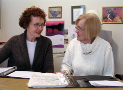 Teresa Hildebrand, left, talks with Barbara Buti about some of the people who have sought help from the Good Samaritan Program at St. Joseph University Parish in Terre Haute. The two women are part of the parish’s longstanding commitment to serve the poor and other people in need. (Photo by John Shaughnessy) 
