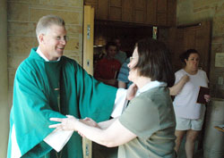 Deacon Michael Stratman greets members of St. Margaret Mary Parish in Terre Haute after a Mass celebrated on Aug. 9 at the parish church. The formation of Deacon Stratman, the 24 other men ordained to the permanent diaconate with him in 2008, and the current class of deacon candidates is supported through the generosity of those who contribute to the annual archdiocesan appeal. (Photo by Sean Gallagher)