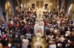 Members of St. Paul Parish in Tell City fill their parish church on Nov. 1 at the start of a Mass to celebrate the faith community’s 150th anniversary as Archbishop Daniel M. Buechlein, Bishop-designate Paul D. Etienne, St. Paul’s pastor, and other priests who have ministered at the parish process into the church. (Photo by Sean Gallagher)