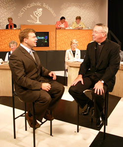 Jay Fadden, left, the executive vice president and general manager of the Boston-based CatholicTV, speaks with then-Father Christopher J. Coyne during a telethon for the network. Father Coyne, who hosted shows on the network, has broadened his communication outlets in recent years by writing a blog. (Submitted photo)