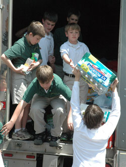 Students from St. Pius X School in Indianapolis load supplies into a semitrailer on May 6. Two days later, the packed semitrailer departed for Alabama to help residents affected by the April 27 tornadoes that caused more than 230 deaths and more than $2 billion in damages in the southern state. (Photo by John Shaughnessy)