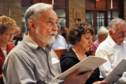 Larry Wickersham, left, and Mary Drake, both members of Prince of Peace Parish in Madison, sing during a workshop for pastoral musicians on Sept. 19 at St. Bartholomew Church in Columbus. The workshop was one in a series sponsored by the archdiocesan Office of Worship to help pastoral musicians across central and southern Indiana become acquainted with new and adapted settings of parts of the new translation of the Mass. Wickersham helps oversee liturgical music at Prince of Peace Parish. (Photo by Sean Gallagher)