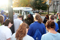 Sophomore students at Bishop Chatard High School in Indianapolis bow their heads as they are led in prayer by a homeless person in downtown Indianapolis. The reverent scene was part of an immersion program to help students learn about the suffering that homeless people experience each day. (Submitted photo)