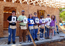 Conventual Franciscan Father John Bamman, second from left, associate pastor of St. Joseph University Parish in Terre Haute, and Rose-Hulman Institute of Technology students, from left, Kyle Bippus, Katherine Czaplicki, Michael Junge, Angelica Cox, Katelyn Stenger and Lisa Lillis help build a house in Tupelo, Miss., during the St. Joseph University Parish campus ministry service trip from Feb. 26 to March 3 as part of Habitat for Humanity’s Collegiate Challenge, a national project to help the poor. (Submitted photo)