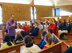 Ken Lolla, head men’s soccer coach at the University of Louisville, speaks to fifth-through eighth-grade students at St. Anthony of Padua School in Clarksville about “Finding Your Gifts,” also the title of his children’s book. Earlier, he spoke to second-graders. His talks were part of the school’s “Step by Step Stewardship” program. (Submitted photo)