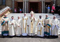 In this April 26 photo, the seven seminarians ordained to the transitional diaconate pose with Archbishop Joseph W. Tobin. They are, from left: Andrew Syberg; Hiep Nguyen (Diocese of Cheyenne); Adam Ahern; Michael Keucher; Archbishop Joseph W. Tobin, Benedictine Brother Philippe Tchalou (Monastere de l’Incarnation, Togo, West Africa); Gerard Carrillo (Diocese of Cheyenne); and Benedictine Brother Luke Waugh (Saint Meinrad Archabbey). (Photo courtesy of Saint Meinrad Seminary and School of Theology)