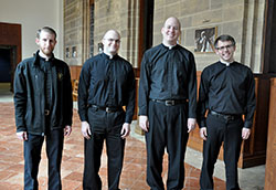 Transitional deacons Daniel Bedel, left, David Marcotte, Tim Wyciskalla and Benjamin Syberg pose on March 27 outside the St. Thomas Aquinas Chapel at Saint Meinrad Seminary and School of Theology in St. Meinrad. All four deacons, scheduled to be ordained priests on June 7 at SS. Peter and Paul Cathedral in Indianapolis, are graduates of Bishop Simon Bruté College Seminary in Indianapolis. (Photo by Sean Gallagher)