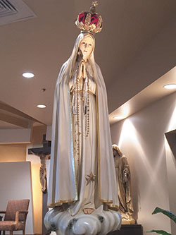 A traveling replica of the Our Lady of Fatima statue at the shrine in Portugal stands on the altar of St. Paul Church of St. John Paul II Parish in Sellersburg on Aug. 25, 2016, during a national tour of the statue. (File photo by Natalie Hoefer)