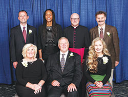 Catholic Charities Indianapolis presented four individuals and a business with Spirit of Service Awards during an April 26 dinner in Indianapolis. Award recipients, seated from left, are Karen and Don Beckwith and Grace Albertson. Standing, from left, are John Ryan, president and CEO of Hall, Render, Killian, Heath & Lyman law firm; keynote speaker Tamika Catchings; Msgr. William F. Stump, archdiocesan administrator; and award winner Gary Gadomski. (Submitted photo by Rich Clark)