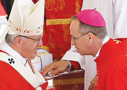 Pope Francis greets Archbishop-designate Charles C. Thompson of Indianapolis as he presents a pallium to the archdiocese’s new shepherd during a Mass marking the feast of SS. Peter and Paul in St. Peter’s Square at the Vatican on June 29. New archbishops from around the world received their palliums from the pope. The actual imposition of the pallium will take place in his archdiocese. (CNS photo/Paul Haring)